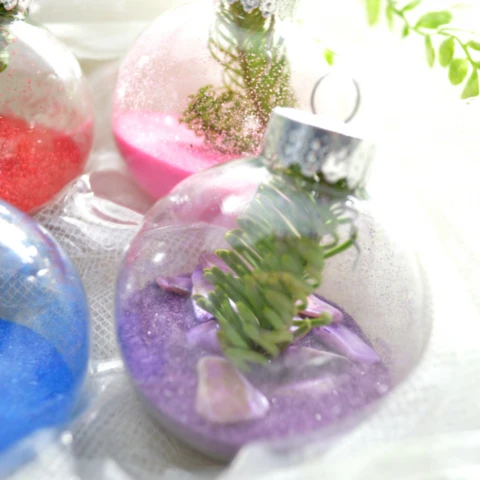 colored sand ornaments with red, blue, purple and pink sand